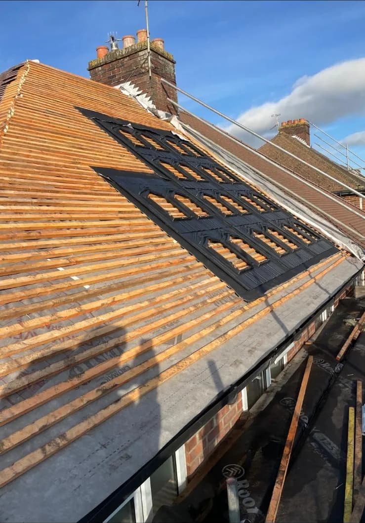 Stripped roof with new battens and in-roof solar mounting set out