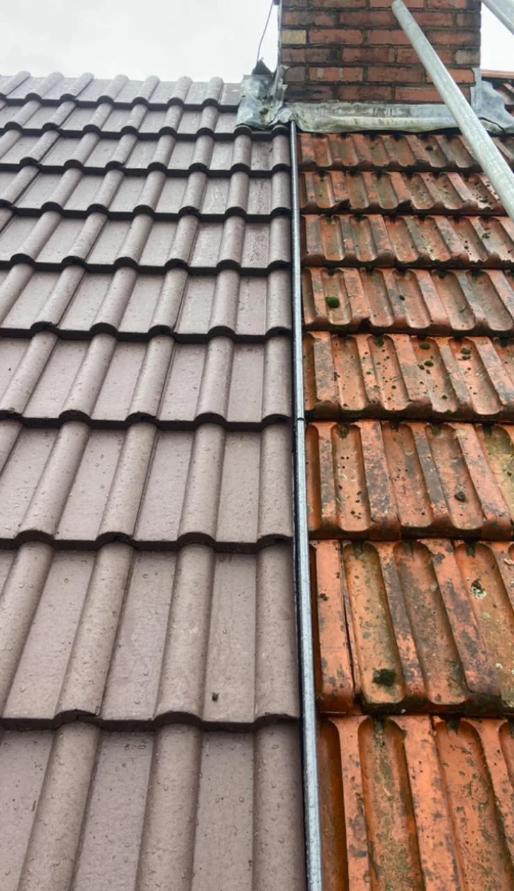 Old weathered roof tiles next to new concrete tiles during a re-roof