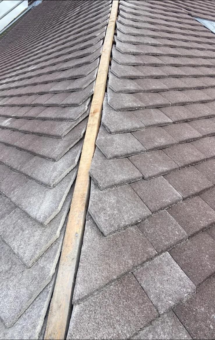 Grey slate-effect roof tiles cut into a valley
